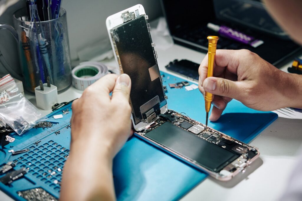 smartphone repairman removing screws 274689 4838 smartphone repairman removing screws 274689 4838
